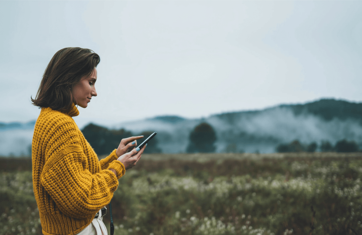 Man using a phone in the mountains